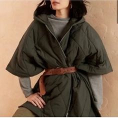 Oversized. Converts From Poncho To Shawl To Blanket. Hooded Quilted Poncho. Kimono Sleeves. Front Yoke. Zipper Closure. Three Button Side Closures. Double Welt Pockets. Straight Hem. Unlined. Please Note The Size Of This Jacket Is Labeled S-M And Meant To Be Worn Oversized. If You Wear A L-Xl The Jacket Will Fit. Oversized Cold Weather Cape, Oversized Cape Outerwear For Spring, Chic Winter Outerwear With Batwing Sleeve, Chic Outerwear With Batwing Sleeves For Layering, Oversized Cape For Layering, Green Cape Outerwear For Fall, Green Fall Cape Outerwear, Chic Oversized Outerwear With Batwing Sleeve, Green Cape For Fall