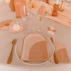 the table is set with plates, napkins and place settings for guests to eat