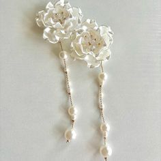 White flower earrings with pearls. They are perfect for wedding or special occasions🤍 *HOW TO CARE FOR YOUR EARRINGS: *I would recommend not to wear it when showering, sleeping or exercising.  *Please avoid contact with lotion, perfumes or chemicals.  -Size: Flower about 1.5 inches (40mm)             Total length about 4.5 inches (120mm) -Color: White  -Processing time: 1-2 days  Thank you so much for supporting my small business and I hope you will like them💭 Feel free to contact me if you ha White Flower Earrings, Pearl Earrings Handmade, White Flower Earring, Pearls Earrings, Bridal Gift, Earrings Wedding, Bridal Gifts, White Flower, Flower Earrings