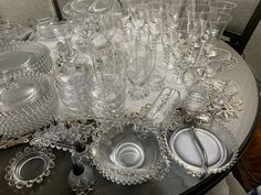 a table topped with lots of glasses and plates