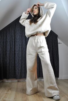 This is a super cool pair of modern tracksuit pants. Very flattering, trendy loose flared cut. Elasticated waist with inside drawstring. It has got a stitched crease for modern edgy look.  The color is very flattering to any complexion as it is glowy warm off white, natural.  The fabric is very high quality, made in Poland, with added hemp for its incredible properties (strength, absorbency, breathability, antimicrobial, sustainability). Here is a matching hoodie: https://www.etsy.com/listing/16 Beige Wide Leg Sweatpants For Streetwear, Beige Wide-leg Sweatpants For Streetwear, Beige Relaxed Fit Wide Leg Sweatpants, Beige Relaxed Fit Wide-leg Sweatpants, Beige Wide Leg Relaxed Fit Sweatpants, Sporty Flare Pants For Loungewear, Beige Wide-leg Relaxed Fit Sweatpants, Sporty Flare Lounge Pants, Oversized Beige Cotton Pants