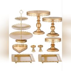 an assortment of gold and white cake stands, serving trays and candlesticks