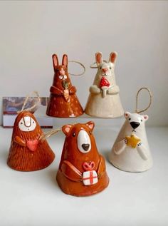 five ceramic christmas ornaments in various shapes and sizes