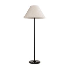 a floor lamp with a white shade on it's base and a black stand