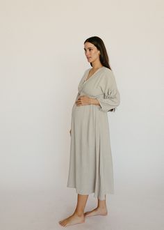 Pregnancy, postpartum and nursing - this dress does it all! This linen midi dress is light and flowy, it pairs beautifully with a bump and is nursing friendly. The soft grey color, front tie detail and peasant sleeve are understated feminine details. You'll feel like you're the star of your own Nancy Meyers movie in th Peasant Sleeve Dress, Maternity Dresses Modest, Modest Pregnancy Outfits, Maternity Occasion Wear, Lounge Wear Ideas, Bump Friendly Dress, Linen Maternity Dress, Maternity Fits, Postpartum Outfits