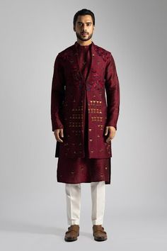 Deep red long nehru jacket with a button at the waist and resham and sequin embroidery. Paired with a long embroidered kurta and cream pant. - Aza Fashions Red Long Sleeve Bandhgala For Designer Wear, Red Designer Nehru Jacket For Festive Occasions, Designer Red Fitted Nehru Jacket, Red Nehru Jacket For Festive Designer Wear, Red Fitted Nehru Jacket For Designer Wear, Festive Red Long Sleeve Bandhgala, Festive Long Sleeve Red Bandhgala, Designer Nehru Jacket For Festive Winter Occasions, Fitted Red Nehru Jacket With Zari Work