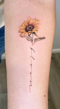 a sunflower with the word love written in cursive writing on its side