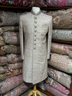 Slate Grey sherwani is enhanced with woven work all over and highlighted in detailed buttons and mandarin collar enriched in thread and mirror.This designer sherwani is complimented with matching churidar bottom. Size:38/S, 40/M,44/XL,46/XXL Occasion: Wedding Ceremony or Reception WASH CARE INSTRUCTIONS - Please Dry clean only when it is applicable. Slight color variation is possible due to digital photography. Ready to Ship! Designer Brocade Sherwani With Chikankari Embroidery, Designer Brocade Bandhgala With Resham Embroidery, Traditional Silver Kurta With Resham Embroidery, Designer Brocade Bandhgala For Eid, Traditional Silver Kurta With Traditional Drape, Designer Brocade Sherwani For Eid, Designer Sherwani With Intricate Embroidery For Diwali, Designer Brocade Sherwani For Festive Season, Designer Brocade Sherwani For Festive Occasions