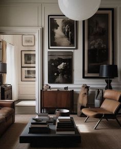 a living room filled with furniture and pictures on the wall