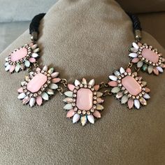 Blush, Pearl & Rhinestone Flowers Attached To Smooth, Twisted, Black Cord. Connection To Flowers & Chain Extender Brass Toned Patinaed. Never Worn. Still In Packaging. Adjustable Pink Necklace With Stones, Adjustable Pink Stone Necklace, Pink Adjustable Necklace With Stones, Pink Stone Necklace With Adjustable Fit, Pink Rhinestone Jeweled Necklace For Parties, Pink Jeweled Rhinestone Necklace For Party, Elegant Pink Crystal Necklace For Party, Pink Rhinestone Necklace For Party, Pink Rhinestone Party Necklace