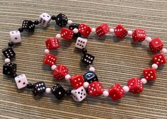 I have been sold out of my dice jewelry for a while and finally made time to make more and post it. This set includes 2 stretch bracelets and 2 pair of earrings that match. The bracelet fit about 7 1/2 = 8 inch wrists. If you like your bracelets loose, hanging on the top of your hand, then they will work for down to 7 inch wrists. One bracelet is red dice with white dots, other bracelet is black dice with white dots and white dice with black dots. There is a pair of earrings in red dice and a pair of earrings with black dice. Priced to sell. These are lightweight as all the dice are acrylic. Don't miss these.  Split up for gives if you want to stretch your money. Dice Jewelry, Red Dice, Dice Earrings, Black Dots, Matching Earrings, Stretch Bracelets, Jewelry Set, Jewelry Sets, Black And Red