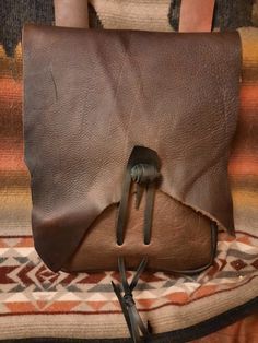 a brown leather purse with two handles on it