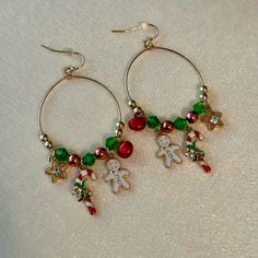 the earrings are decorated with christmas decorations and teddy bear charmes, along with beads