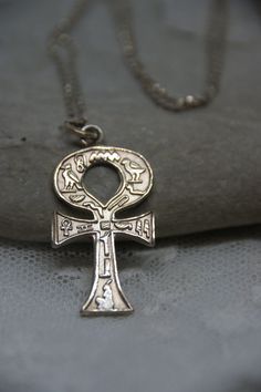 This is a superb piece of Egyptian jewellery and dates from c1970s. The pendant is a solid Silver Ankh (Egyptian Cross) also known as the key of life.  It is decorated with beautiful hieroglyphic symbols.  The pendant is also Silver.  Both items are stamped 925 (Silver).  The pendant measures:  3.1cm (including the bale)  by 1.7cm. The chain measures:  51cm. Antique Ankh Collectible Jewelry, Vintage Ankh Metal Necklace, Vintage Ankh Necklace In Metal, Vintage Metal Ankh Necklace, Silver Ankh Necklace In Brass, Silver Ankh Necklace For Ceremonial Use, Silver Ankh Necklace For Ceremonial Occasions, Vintage Silver Ankh Jewelry, Vintage Engraved Ankh Jewelry