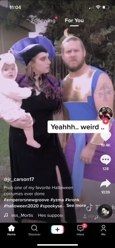 two men and a woman dressed up in halloween costumes, one is holding a baby