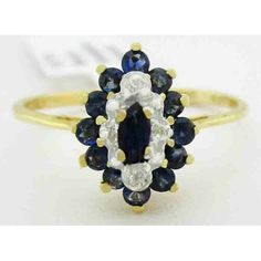 Total Carat Weight: 0.30 Carats Secondary Stone: Diamond Main Stone Color: Blue Number Of Diamonds: 4 Ring Size: 7.25 (Free Resizing Service - If Needed) Main Stone Shape: Round Base Metal: Gold Setting Style: Prong Material: Gemstone Cut Grade: Very Good Metal Purity: 10k Main Stone: Blue Sapphire Metal: Yellow Gold Classic Blue Marquise Diamond Ring, Blue Diamond Cluster Ring With Prong Setting, Blue Cluster Ring With Prong Setting For Anniversary, Blue Marquise Diamond Ring With Diamond Cut, Blue Diamond Cluster Ring For Formal Occasions, Blue Cluster Diamond Ring With Halo Setting, Blue Marquise Cut Diamond Ring With Vvs Clarity, Classic Blue Marquise Cut Diamond Ring, Blue Cluster Ring For Formal Occasions