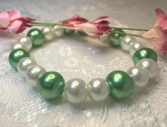 "Dress up any outfit with this beautiful and classic green and white pearl bracelet.  This green bracelet is made with large faux pearls and it sized to fit an averaged 7\" wrist.  Jewelry makes an excellent gift for Valentine's Day, Mother's Day, Easter, Christmas, birthdays, anniversaries, or as prom and pageant jewelry.   There are a limited number of these gorgeous bracelets, so don't wait, or they'll be gone! Looking for other jewelry? Check out my store at www.etsy.com/shop/jenajewelrybox for more stunning jewelry." Green Pearl Jewelry, Pageant Jewelry, Pearl Jewelry Gift, White Pearl Bracelet, Green Bracelet, Wrist Jewelry, Green Pearls, Wedding Jewelry Bracelets, Wife Gift