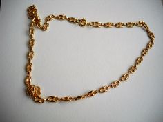 This gold plated brass choker is composed by a link chain, where the links remind coffee beans. It will not let you go unnoticed while stating your elegance with its simplicity and exclusive design. This chain, made in Germany, was acquired in the early 1980s. The choker is delivered with 40-45-50 cm (15.7-19.7 inches) lengths or any other length (for a longer necklace or a shorter bracelet); the photograph of the model is 40 cm and the lock can be either as in the photo (pressed brass clasp) or Gold Link Chain Necklace With Lobster Clasp, Vintage Gold Cable Chain Necklace, Gold Rolo Chain Link Necklace, Yellow Gold Rolo Chain Metal Necklace, Gold Chain Necklace With Rectangular Rolo Links, Gold Rolo Chain Necklace With Rectangular Links, Vintage Cable Chain Necklace As Gift, Vintage Cable Chain Necklace Gift, Brass Choker