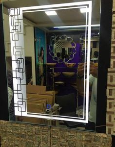 a mirror that is sitting on top of a table in front of a wall with boxes