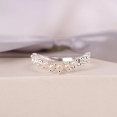 a close up of a ring with pearls on it