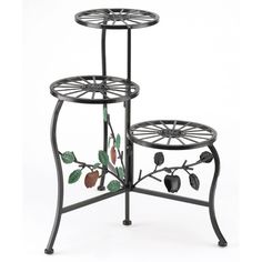 two tiered metal plant stands with leaves and berries painted on the sides, one holding an umbrella