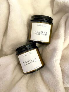 two jars of vanilla almond jam on a white blanket