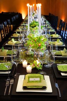 the table is set with green napkins and place settings