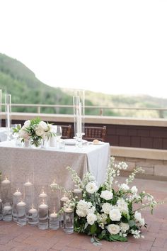 the table is set with candles and flowers