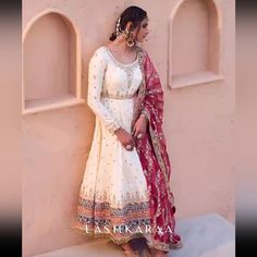 Heavy White And Pink Anarkali From Lashkaraa With A Churidar Pajama White Floor-length Lehenga With Dabka, White Dabka Lehenga For Festivals, White Lehenga With Dabka For Festivals, White Fitted Salwar Kameez With Naqshi Detailing, Fitted White Lehenga With Dabka, Fitted White Lehenga With Dabka Detail, White Traditional Maxi Dress For Wedding, White Naqshi Anarkali Set For Wedding, Anarkali Choli With Naqshi In Traditional Drape