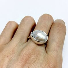 This is a handmade pearl ring using a one of a kind asymmetrical pearl with a drop shape (almost).Please have in mind that every pearl used for this ring is unique so every ring is will be unique.The band for this ring is made of sterling silver rectanle wire 1.8mm.The ring can be made in sterling silver or gold plated sterling silver.MATERIALS:sterling silver 925 or gold plated sterling silver 925DIMENSION:15-17mm size of pearlI can make this ring to your size.If you don't know your size please Handmade Minimalist White Pearl Ring, Minimalist Handmade White Pearl Ring, Ring Minimal, Ring Pearl, Minimal Ring, Gold Statement Ring, Contemporary Ring, Ring Minimalist, Minimalist Ring