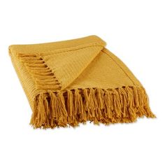 a yellow throw blanket with fringes on the bottom and one end folded in two rows