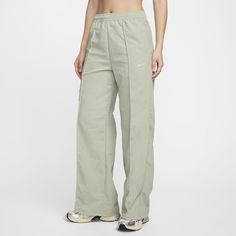 Simplicity meets functionality. These crisp, crinkled pants have everything you need for all-day wear: water-repellent fabric, multiple pockets and an adjustable design. A bungee toggle at the hem means you can tighten it for a jogger-like fit or keep it open for a relaxed look. You've got stylish options—rain or shine. Functional Solid Bottoms With Cargo Pockets, Functional Full-length Bottoms With Cargo Pockets, Functional Trousers With Hip Pockets, Functional Full-length Bottoms With Side Pockets, Nike Nylon Bottoms With Elastic Waistband, Green Nylon Sport Pants, Green Nylon Sports Pants, Functional Gym Pants With Pockets, Sporty Wide Leg Parachute Pants With Hip Pockets