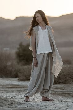 "Meet our relaxed Linen Harem Pants from the \"Desert Hues: Agender Linen Collection.\" These gender-neutral adult pants are all about easy-breezy style, taking inspiration from the calming shades of the desert. Created from soft, breathable linen, these pants are your go-to choice for both comfort and fashion, especially in the hot weather. The fabric's natural texture adds an authentic touch, reflecting the raw beauty of the desert sands. Choose from three natural shades:  1. Classic Natural Flax Color - made of lightweight linen, these pants are the lightest in this collection. 2. Natural Flax and White Melange - made of medium-weight linen. 3. Natural Flax and Gray Melange - made of medium-weight linen, but a little bit heavier and good for the cooler weather.  These natural linen pant Flax Outfits, Wabi Sabi Style Clothes, Desert Aesthetic Outfit, Desert Clothes, Desert Aesthetic Fashion, Cycle Breakers, Flax Dress, Desert Clothing, Gender Neutral Outfit