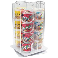 a stack of cereal cups and yogurts on a white stand with two shelves