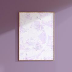 a purple wall with a wooden frame hanging on it's side in an empty room