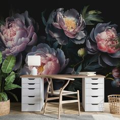 a desk and chair in front of a floral wall mural