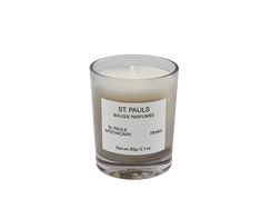 a candle that is sitting on top of a white surface with the words st pauls in