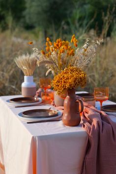 a table with plates and vases on it