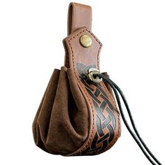 a brown leather case with an intricate design on the front and side, attached to a black cord