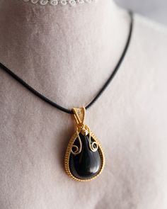 This captivating pendant necklace features a one-of-a-kind teardrop shape Obsidian gemstone, artfully handmade with 14K gold fill wires and suspended from a luxurious black leather tie with a lobster clasp. Pictures cannot fully reflect the beauty of this gemstone pendant - it is an exclusive piece of jewellery from the Artisan Made collection and will be the perfect accessory for your daily excursions and ideal for layering alongside other necklaces. The length of necklace can be adjustable up Leather Tie, Black Obsidian, Jewellery Making, Adele, Gemstone Pendant, Crystal Necklace, Lobster Clasp, Favorite Jewelry, Necklace Etsy