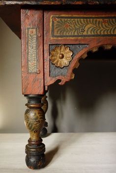 an old wooden table with ornate carvings on it