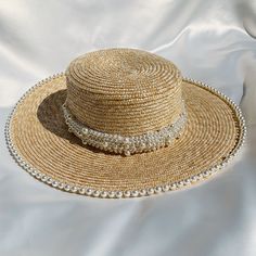 Handwoven straw hat with pearl trim detailing Band at centre of hat is removable Circumference 56-59cm (can be adjusted slightly with inner drawstring) Brim 10cm Made in UK Woman owned small business  Handmade Elegant Adjustable Braided Hat, Elegant Brimmed Straw Hat Made Of Paper Straw, Elegant Woven Brimmed Straw Hat, Elegant Handmade Panama Hat For Vacation, Elegant Adjustable Woven Boater Hat, Elegant Adjustable Woven Straw Hat, Elegant Braided Straw Hat For Beach, Elegant Handmade Sun Hat For Vacation, Elegant Braided Hat For The Beach