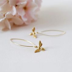 These are lovely bee earrings. Cute little gold bees hang from gold plated long oval hook ear wires. Simple yet adorable, these earrings are great accessories for spring and summer, and would make a wonderful gift for a bee lover :) The bees are made of brass, and measure 13mm.  Total length of these earrings is approx. 2" (54mm). More bee jewelry designs are available in my shop. Some are as seen in the last picture. Thank you for stopping by. Please contact me if you have any questions or need a different quantity :) Custom orders are welcome. ♥ Click the link below to see more beautiful modern earrings: www.etsy.com/shop/LeChaim?section_id=17655958 My shop: http://www.etsy.com/shop/LeChaim About LeChaim: http://www.etsy.com/shop/LeChaim/about an Original and Handmade design of Melanie K Bee Jewellery, Bee Jewelry Gold, Gold Bee Earrings, Gold Bee Necklace, Honey Bee Earrings, Bee Jewelry, Gold Bee, Bee Earrings, Long Dangle Earrings