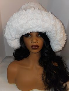 One Size fits most Introducing our exquisite white crochet oversized statement hat, a striking fusion of high-end fashion and cozy elegance. Handcrafted with the finest faux fur polyester, this one-of-a-kind masterpiece is designed for those with a penchant for luxury and a passion for unique, trendsetting style. Experience the unparalleled softness and embrace the captivating allure of this hat, a bold symbol of contemporary sophistication that sets you apart in the world of haute couture.