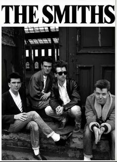 the smiths sitting on steps in front of a black and white photo with their legs crossed