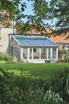 a house with a glass roof in the grass