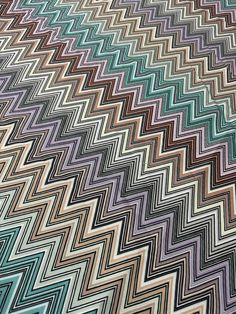 an image of a multicolored chevron pattern on a bed sheet that has been made to look like a zigzag