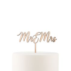 a cake topper with the word mom's written in cursive font