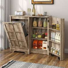 an open storage cabinet in the corner of a room with a painting on the wall