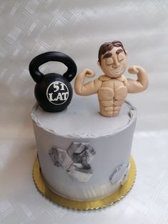 a cake with a man holding a kettle on it's side and a weight sign on top